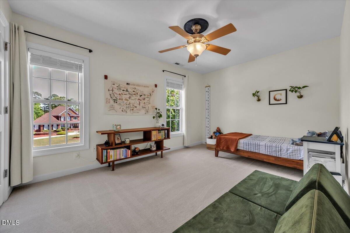 2908 Oak Bridge Drive Raleigh, NC 27610 - Photo 33 of 47 a bedroom with furniture and a large window