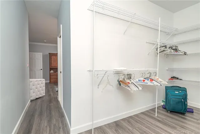 a storage room with wooden floor washer and dryer