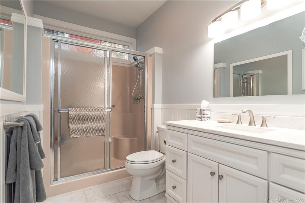 246 North Shore Road Killingly, CT 06241 - Photo 15 of 28 a bathroom with a granite countertop sink toilet and shower