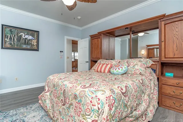 a bedroom with a bed and a painting on the wall