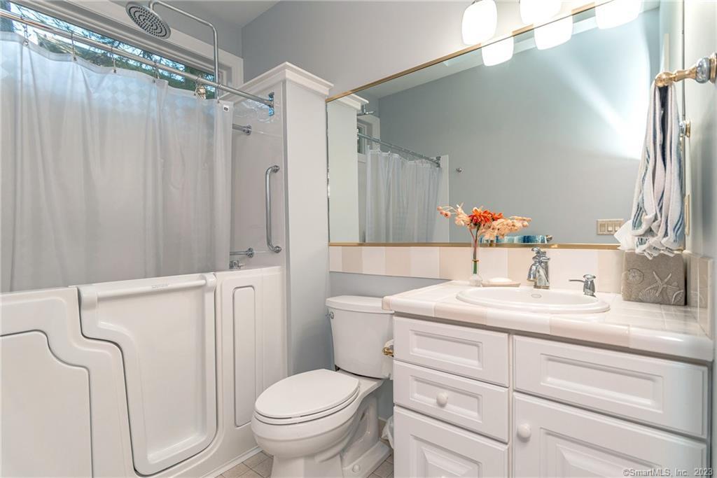 246 North Shore Road Killingly, CT 06241 - Photo 22 of 28 a bathroom with a granite countertop sink toilet and shower
