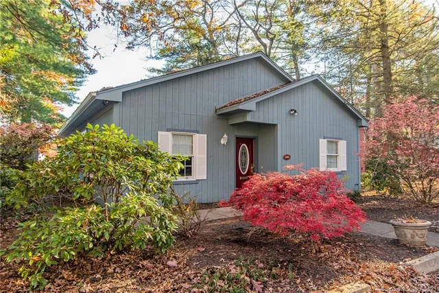 a front view of house with yard and trees around