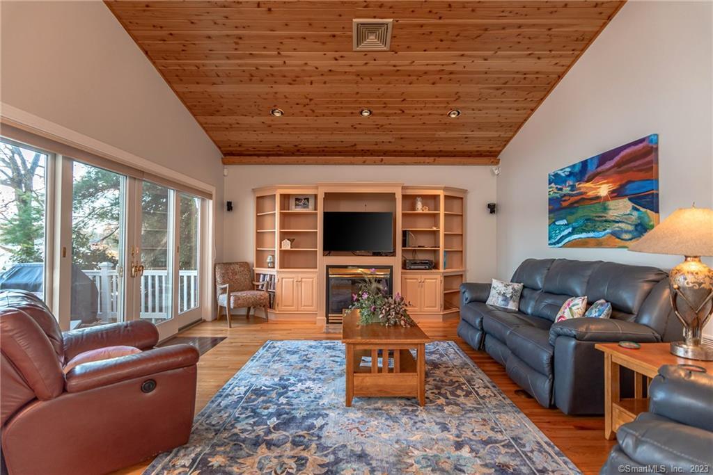 246 North Shore Road Killingly, CT 06241 - Photo 6 of 28 a living room with furniture flat screen tv and a fireplace