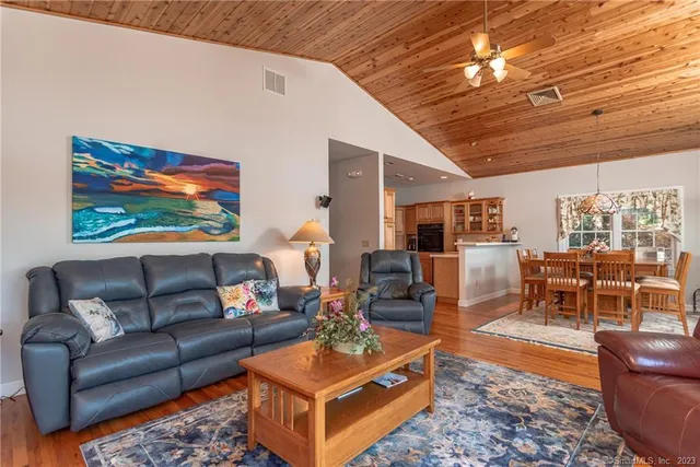 a living room with furniture a table and a painting