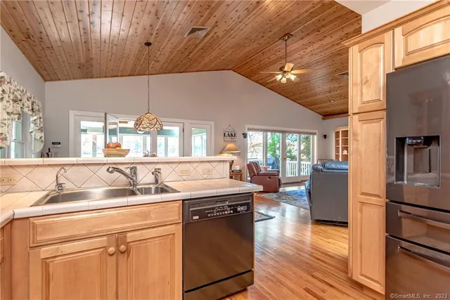 a kitchen with a sink cabinets and wooden floor