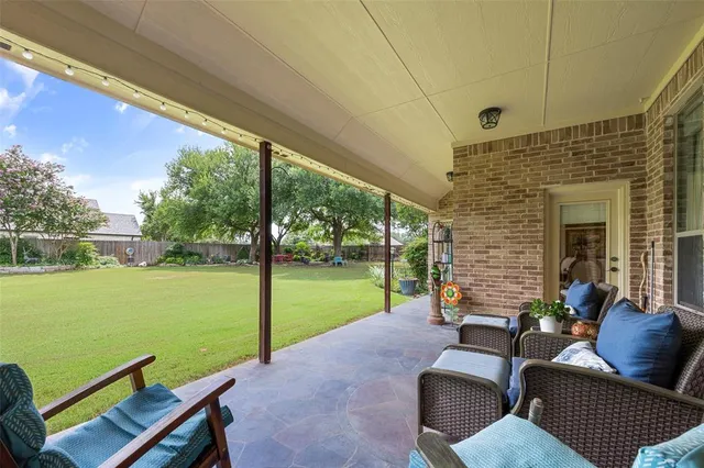 a view of a patio with a yard