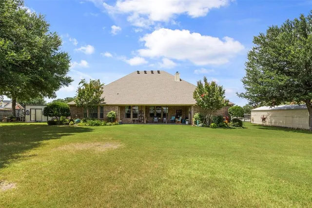a view of a large garden with plants and large trees