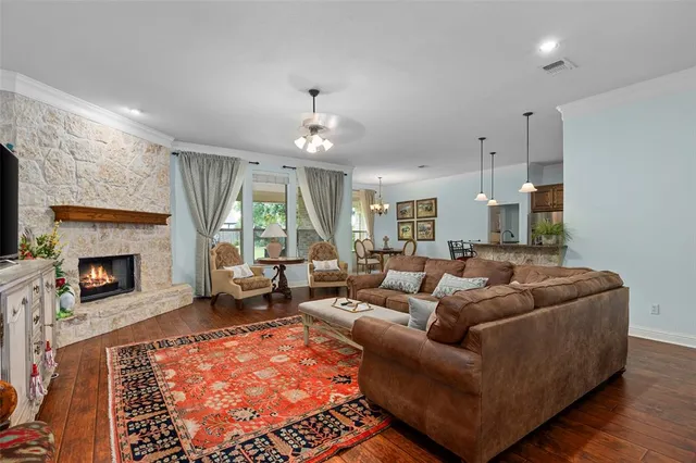 a living room with furniture a large window and a fireplace