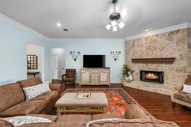 a living room with furniture a flat screen tv and a fireplace
