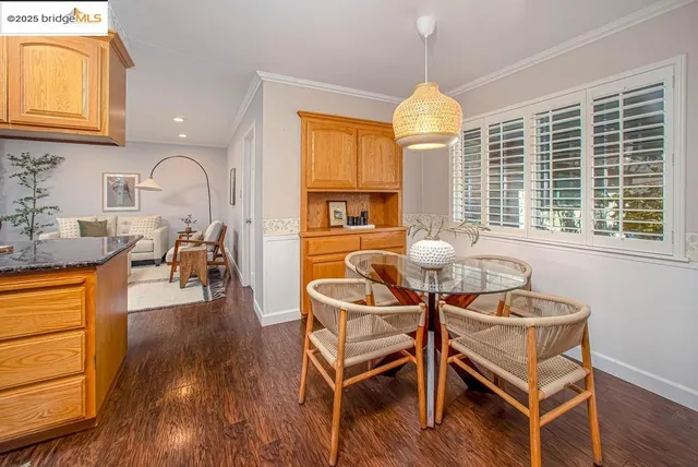 a dining room with furniture a chandelier and wooden floor
