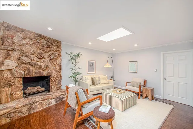 a living room with furniture a large window and a fireplace