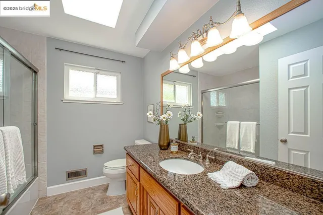 a bedroom with a bed and lamp