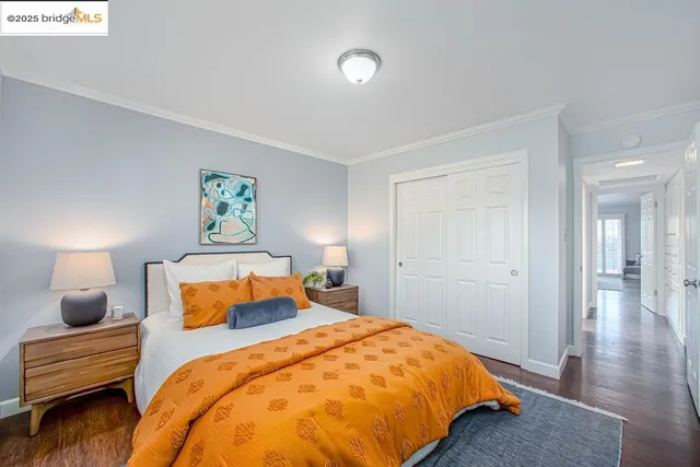 a bedroom with a bed and a lamp next to a window