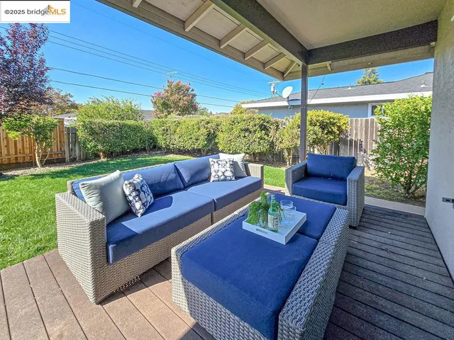 a front view of a house with a yard and potted plants
