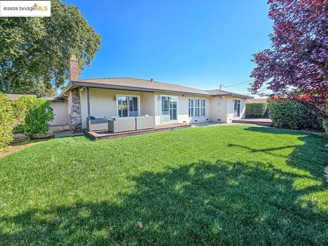 a front view of house with yard and outdoor seating