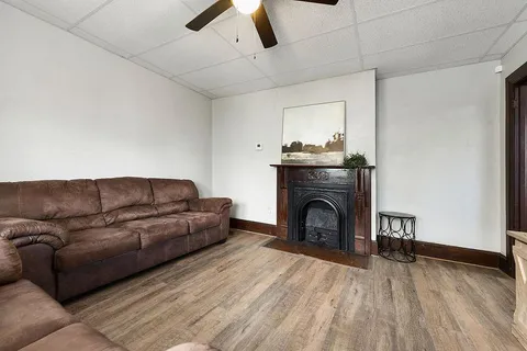 a living room with furniture and a fireplace