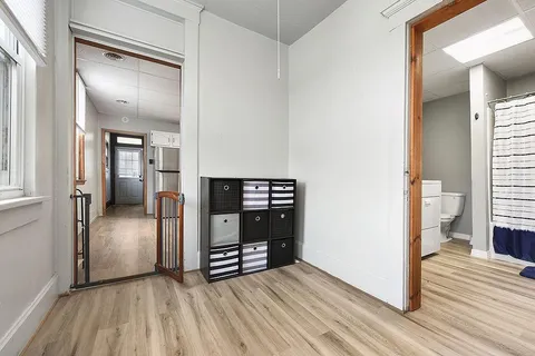 a view of a room with wooden floor