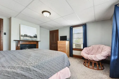 a bedroom with a bed and a chair