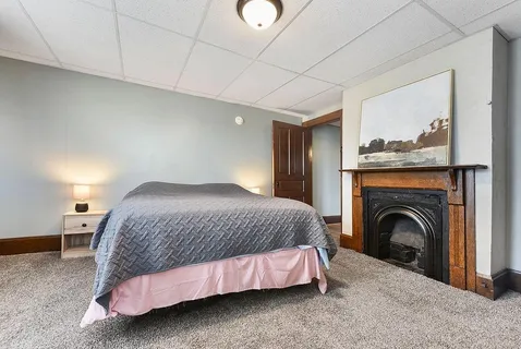 a spacious bedroom with a bed and a window