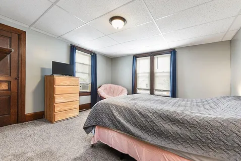 a bedroom with a bed and a dresser