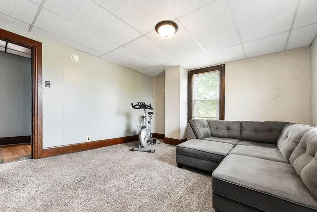 a living room with furniture window and a ceiling fan