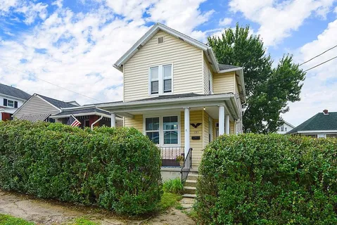 a front view of a house with plants