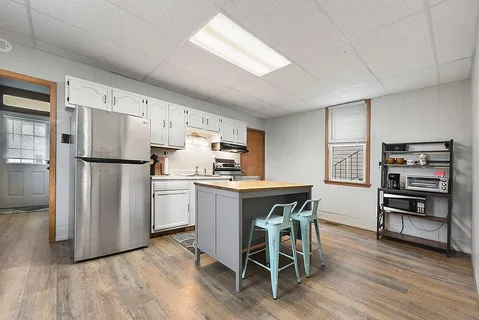 a kitchen with stainless steel appliances a refrigerator and a stove top oven
