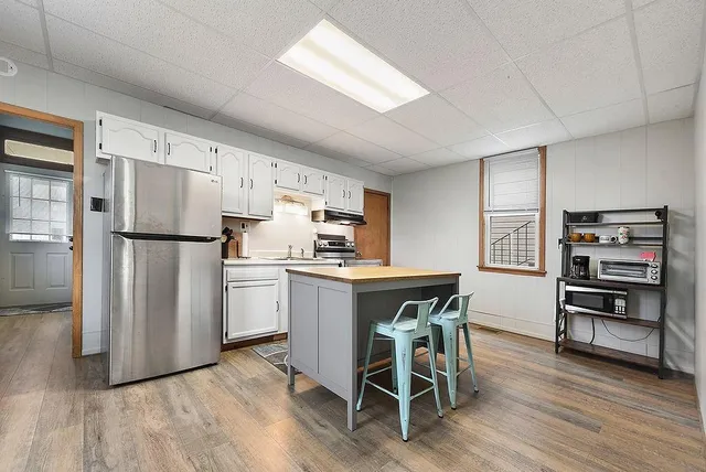 a kitchen with stainless steel appliances a refrigerator and a stove top oven