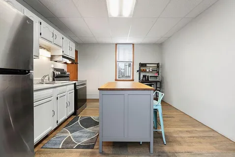 a kitchen with granite countertop a sink appliances cabinets and counter space