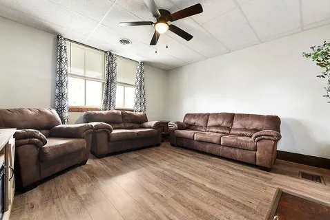 a living room with furniture and a large window