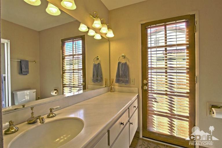 72701 Haystack Road Palm Desert, CA 92260 - Photo 18 of 27 a bathroom with a granite countertop sink and a mirror