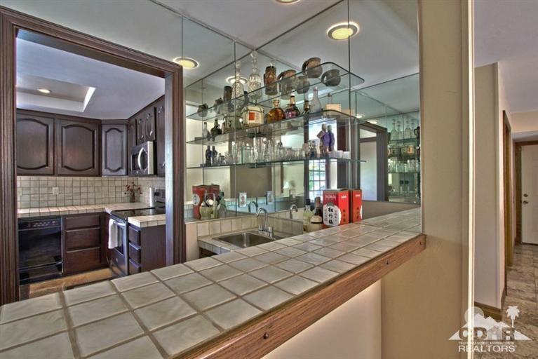 72701 Haystack Road Palm Desert, CA 92260 - Photo 9 of 27 a room with lots of counter top space and stainless steel appliances