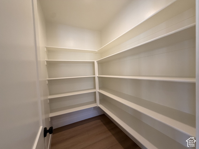 1595 West Canyon Rim Road, Unit 630 Lehi, UT 84048 - Photo 39 of 41 Walk-in pantry featuring extensive white shelving, wood-finish flooring, and a white door with black hardware