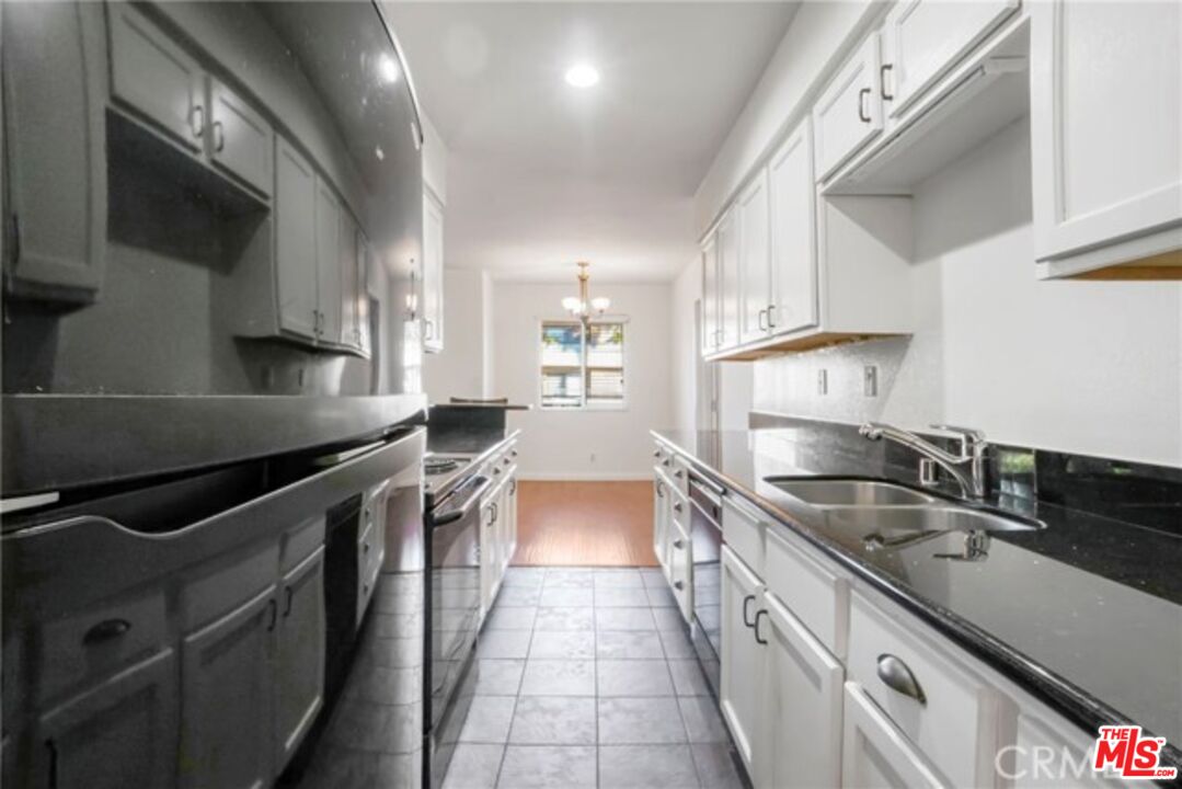 a kitchen with stainless steel appliances granite countertop a sink and stove