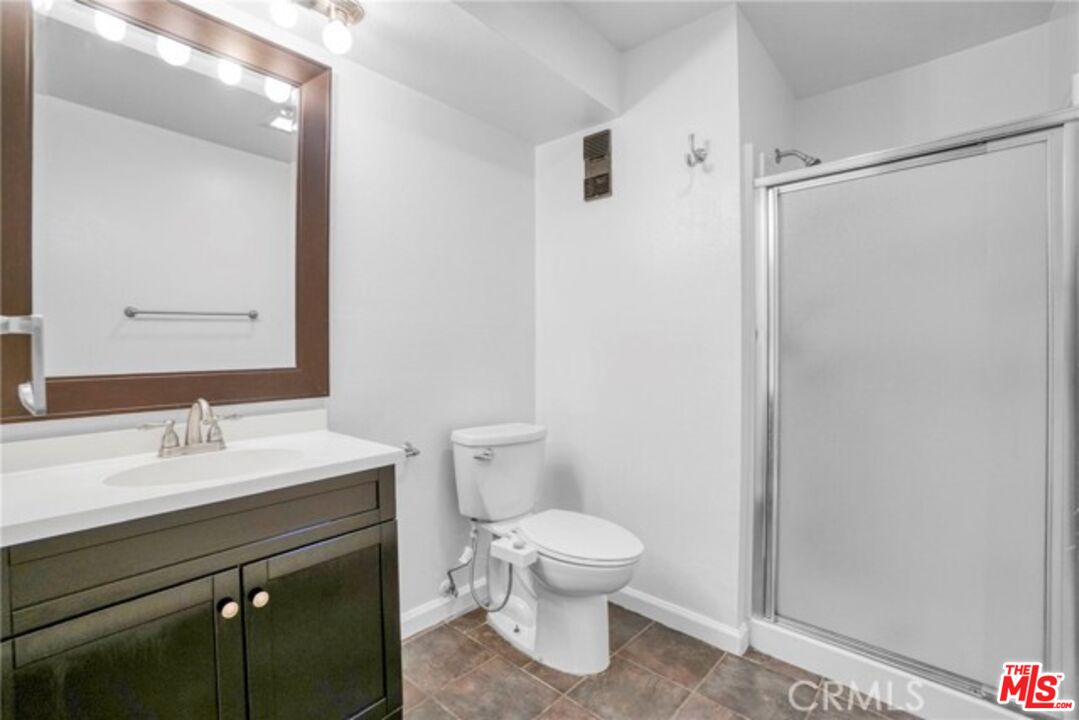 5003 Tilden Avenue, Unit 109 Sherman Oaks, CA 91423 - Photo 13 of 29 a bathroom with a sink a toilet and shower