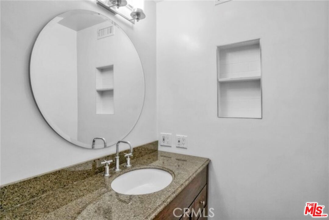 5003 Tilden Avenue, Unit 109 Sherman Oaks, CA 91423 - Photo 15 of 29 a bathroom with a sink and a mirror