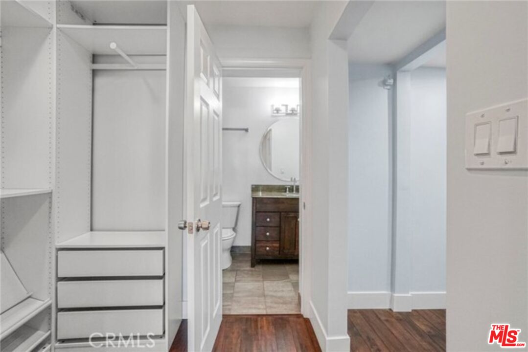 5003 Tilden Avenue, Unit 109 Sherman Oaks, CA 91423 - Photo 17 of 29 a view of a hallway with wooden floor and staircase