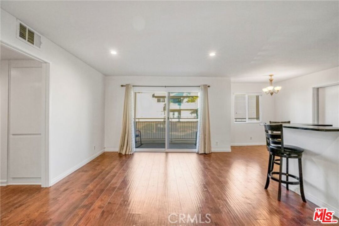 5003 Tilden Avenue, Unit 109 Sherman Oaks, CA 91423 - Photo 5 of 29 a view of empty room with wooden floor and fan