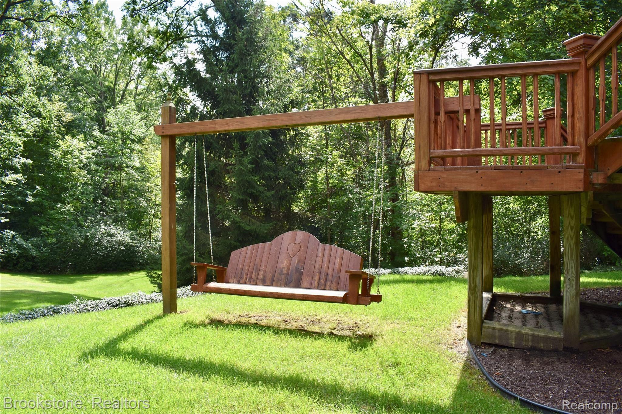 405 Baldwin Ridge Oxford, MI 48371 - Photo 17 of 54 CHECK OUT THIS MASSIVE SWING. JUST IMAGE "SWINGING" OUT HERE ON THOSE WARM SUMMER NIGHTS. THIS IS JUST ANOTHER EXAMPLE OF HOW THIS PROPERTY "WAS DESIGNED FOR ENTERTAINING"