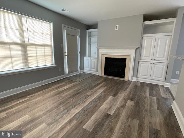 9 Brattleboro Road Swedesboro, NJ 08085 - Photo 11 of 26 a view of an empty room with wooden floor fireplace and a window