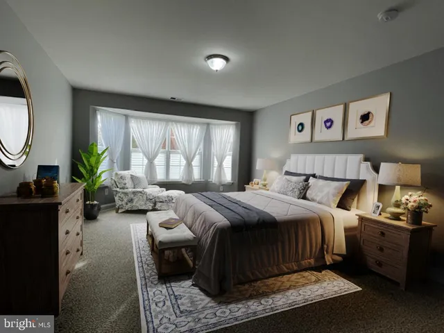 a spacious bedroom with a bed a couch and a window