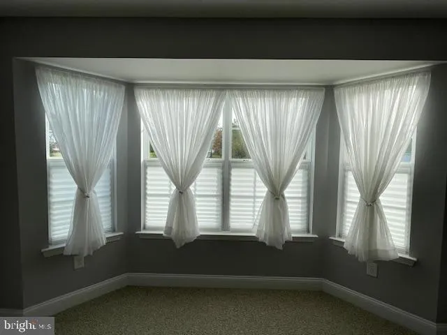 a living room with a large window and front door