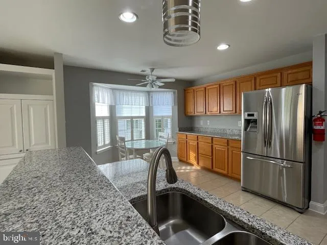 a kitchen with a refrigerator a sink and cabinets