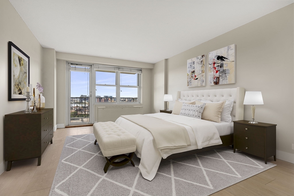 151 Tremont Street, Unit 23P Boston, MA 02111 - Photo 11 of 35 a bedroom with a bed and a large window