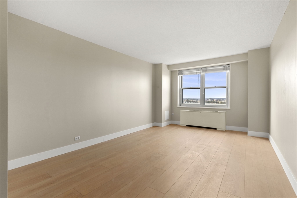151 Tremont Street, Unit 23P Boston, MA 02111 - Photo 18 of 35 a view of an empty room with a window