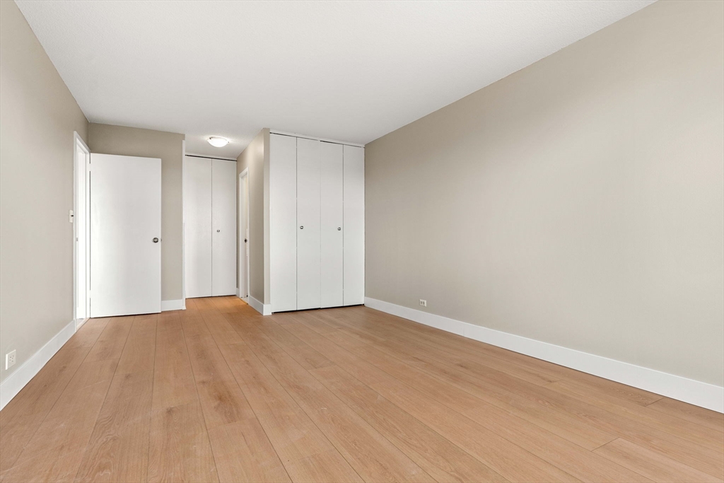 151 Tremont Street, Unit 23P Boston, MA 02111 - Photo 20 of 35 a view of an empty room and wooden floor