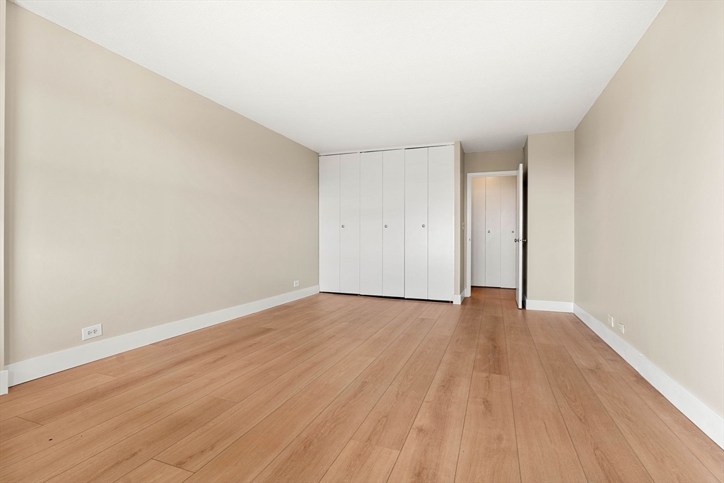 151 Tremont Street, Unit 23P Boston, MA 02111 - Photo 23 of 35 a view of an empty room with wooden floor
