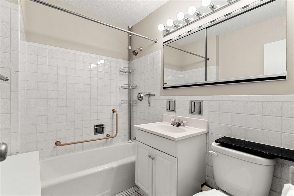 151 Tremont Street, Unit 23P Boston, MA 02111 - Photo 24 of 35 a bathroom with a sink a toilet and shower