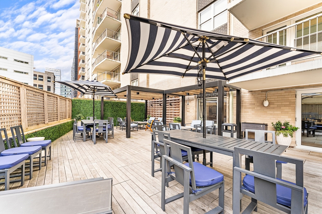 151 Tremont Street, Unit 23P Boston, MA 02111 - Photo 29 of 35 a view of a chairs and table in a patio