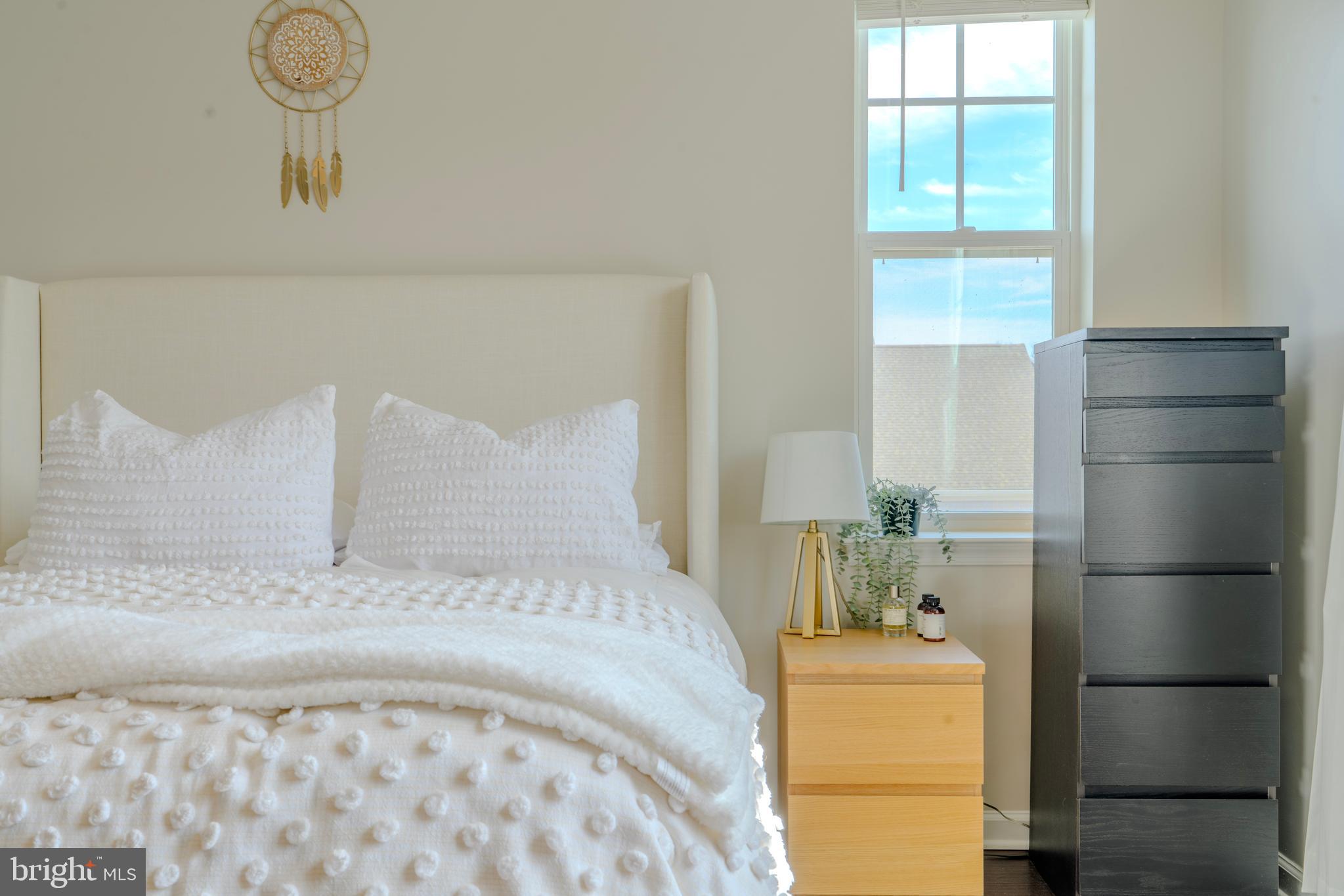 8515 Bald Eagle Lane Frederick, MD 21704 - Photo 22 of 34 a bed sitting in a bedroom next to a window